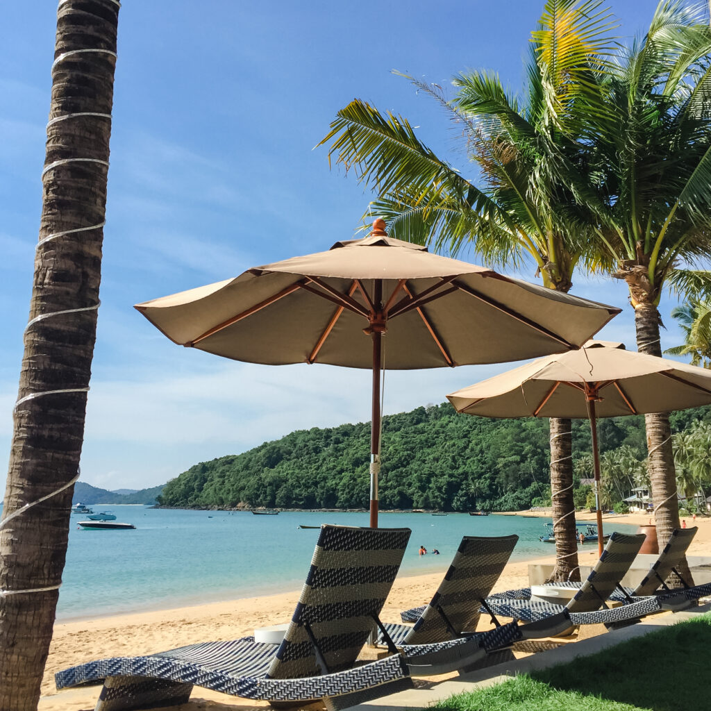 tropical beach landscape with deckchair parasol from nosy be madagascar vintage light filter